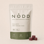 A stand-up pouch of NODD Golf Performance Chews in Wild Berry flavor, shown on a light beige background with three berry-shaped chews placed in front.